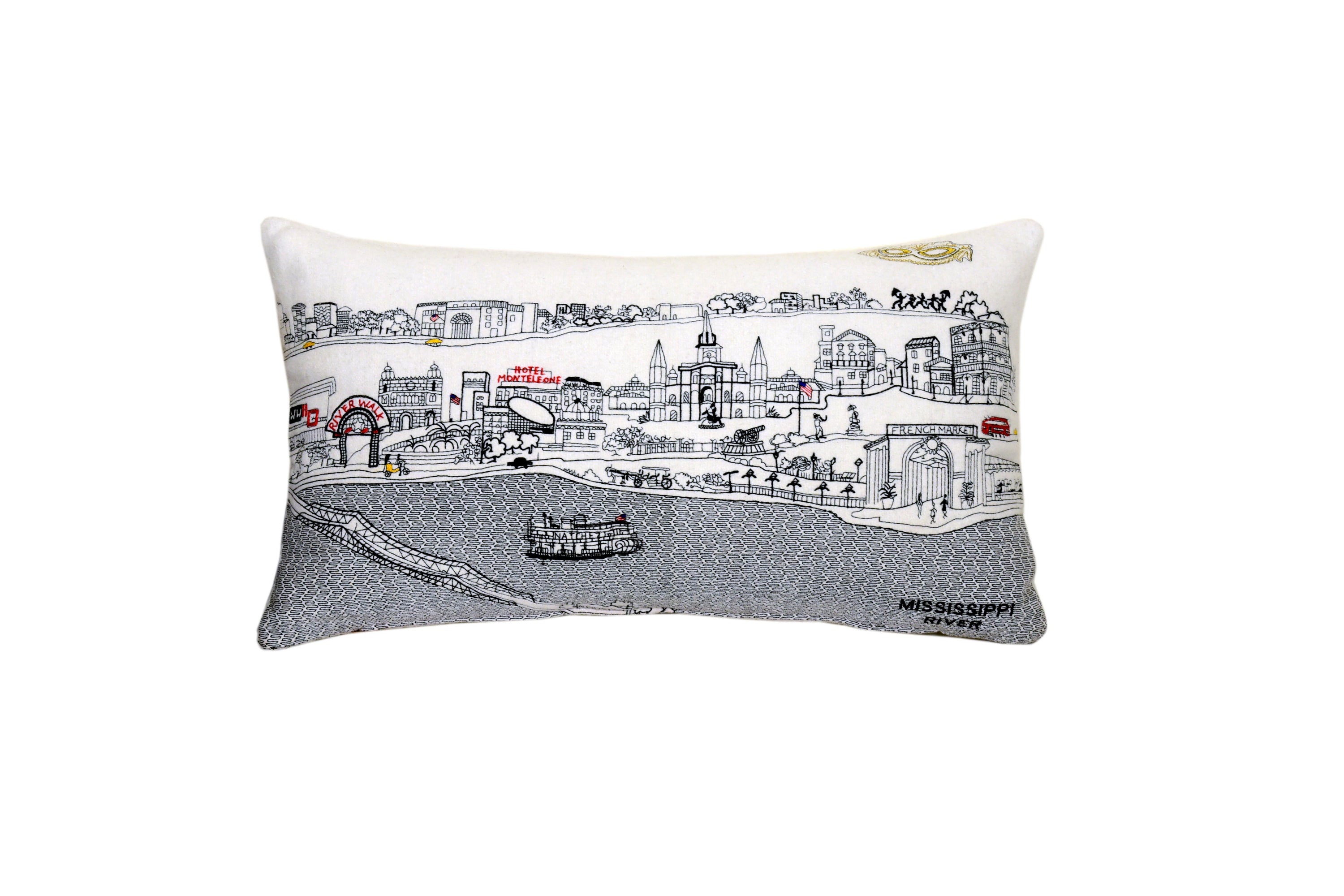 A decorative New Orleans pillow featuring vibrant embroidery inspired by the city's architecture and culture, with a red zipper at the bottom.