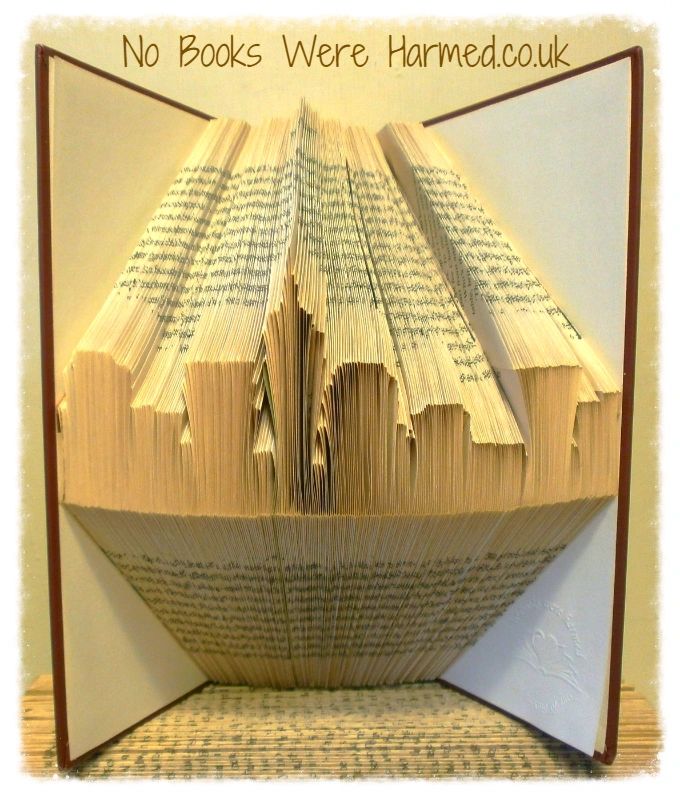 Hand-folded book art depicting the New York Skyline, showcasing intricate details and unique textures from vintage books.