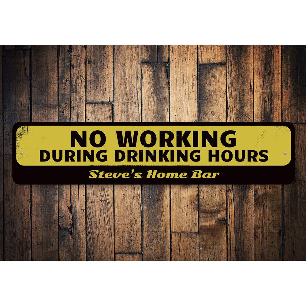 A humorous No Working During Drinking Hours Sign made of high-quality aluminum, featuring bold lettering and a decorative design, perfect for home bars and man caves.