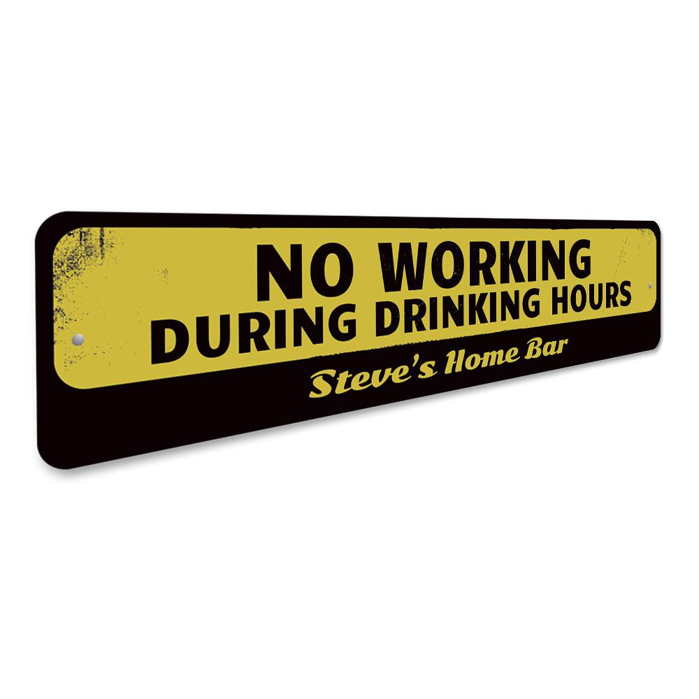 A humorous No Working During Drinking Hours Sign made of high-quality aluminum, featuring bold lettering and a decorative design, perfect for home bars and man caves.