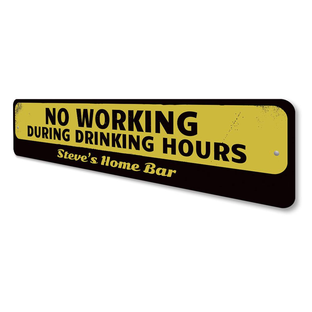 A humorous No Working During Drinking Hours Sign made of high-quality aluminum, featuring bold lettering and a decorative design, perfect for home bars and man caves.