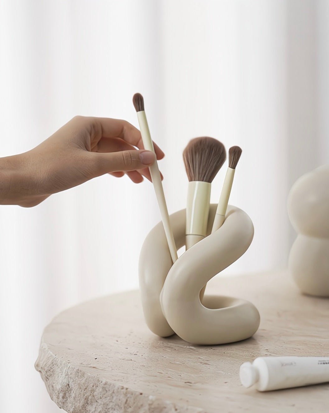 Nordic style ceramic foundation brushes holders elegantly displaying makeup tools on a vanity.