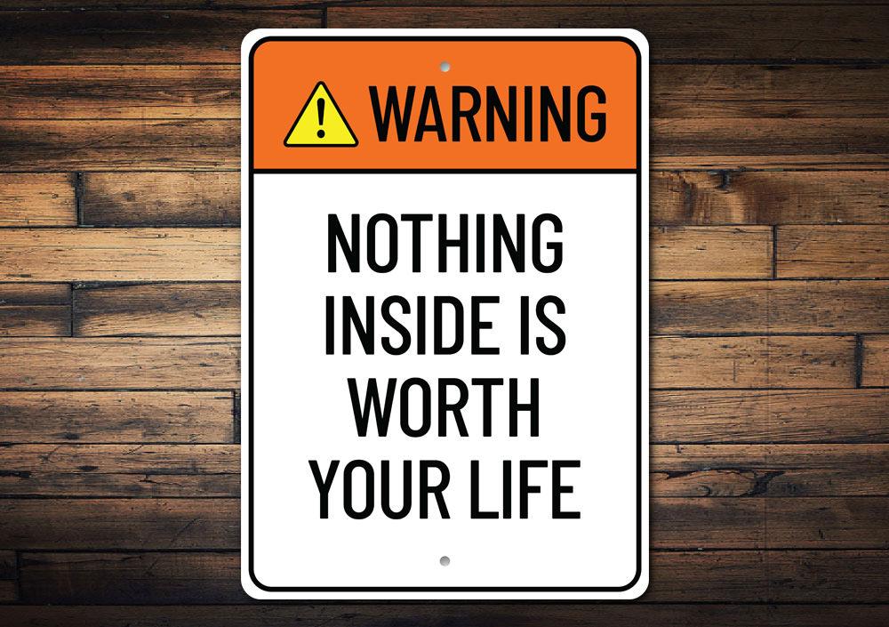 A humorous metal sign reading 'Nothing Inside is Worth Your Life', showcasing a stylish design suitable for home decor.