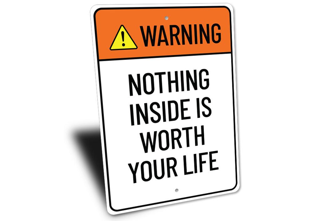 A humorous metal sign reading 'Nothing Inside is Worth Your Life', showcasing a stylish design suitable for home decor.