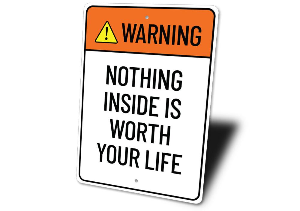 A humorous metal sign reading 'Nothing Inside is Worth Your Life', showcasing a stylish design suitable for home decor.