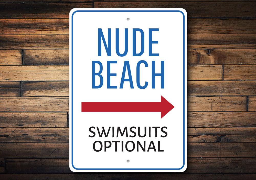 A decorative Nude Beach Sign made of high-quality aluminum, featuring a beach-themed design, perfect for coastal decor.