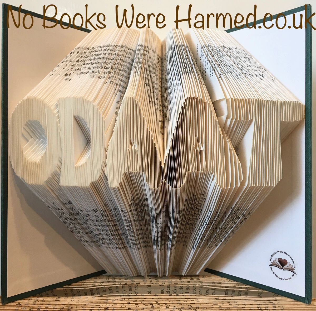 Handcrafted book art titled 'ODAAT' - One Day At A Time, showcasing intricately folded pages from vintage books.