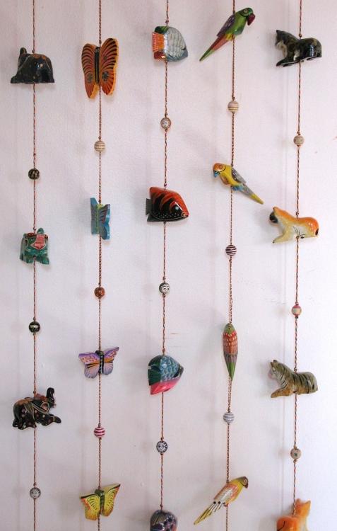 Colorful handcrafted wooden animal hanging brass bells with vibrant designs, featuring fish, birds, and butterflies, perfect for home decor.