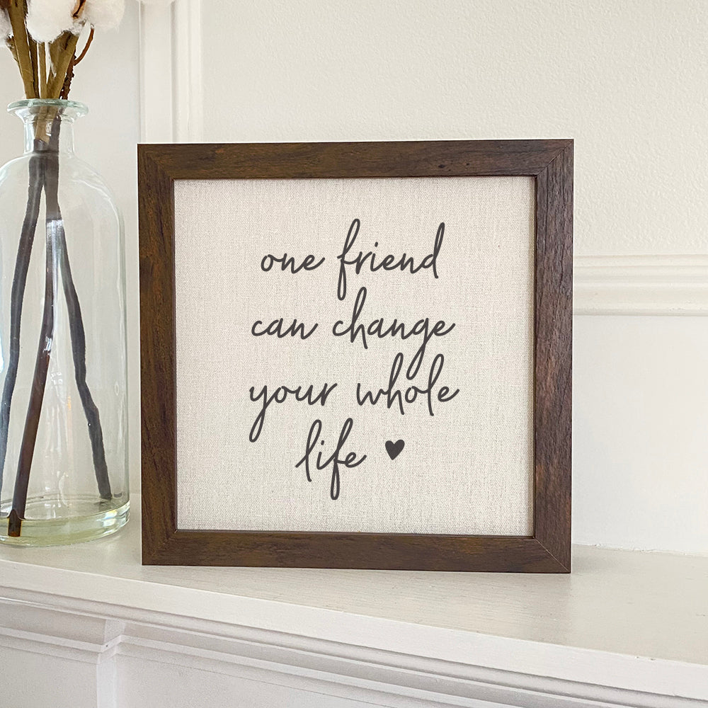 One Friend Framed Sign with a stylized wood frame and eco-friendly ink printing on a linen-look background.