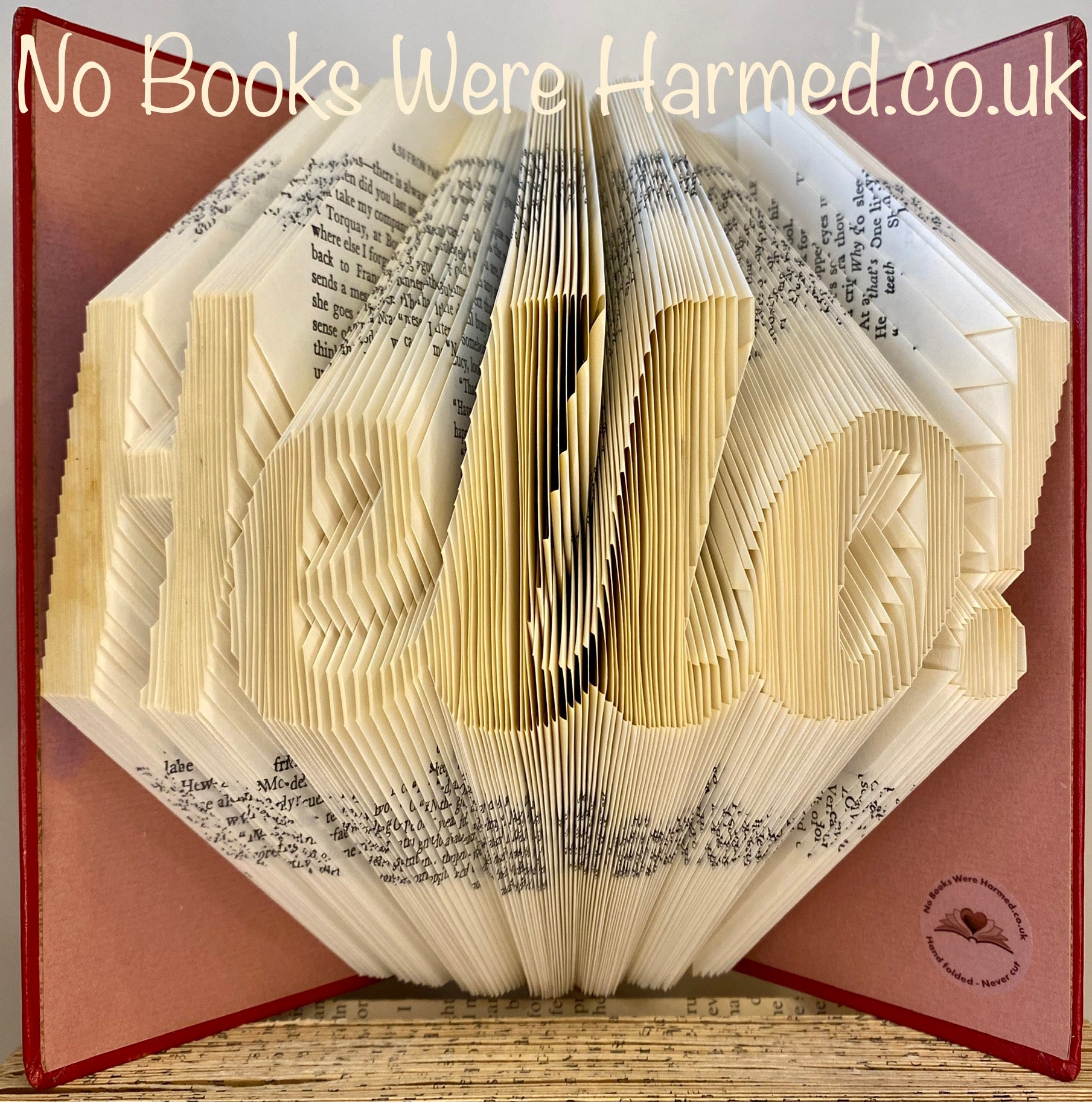 A beautifully crafted piece of book art, hand folded and designed exclusively for subscribers, showcasing intricate details and unique design.