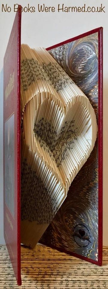 Handcrafted Open Heart art piece made from vintage book pages, showcasing intricate folds and unique design.