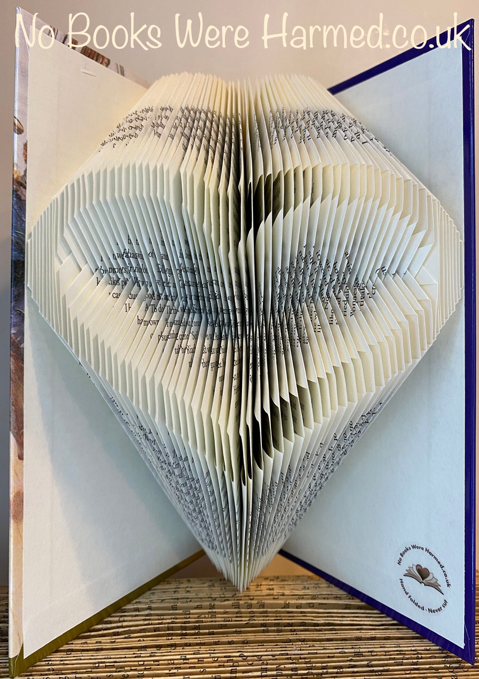 Handcrafted Open Heart art piece made from vintage book pages, showcasing intricate folds and unique design.