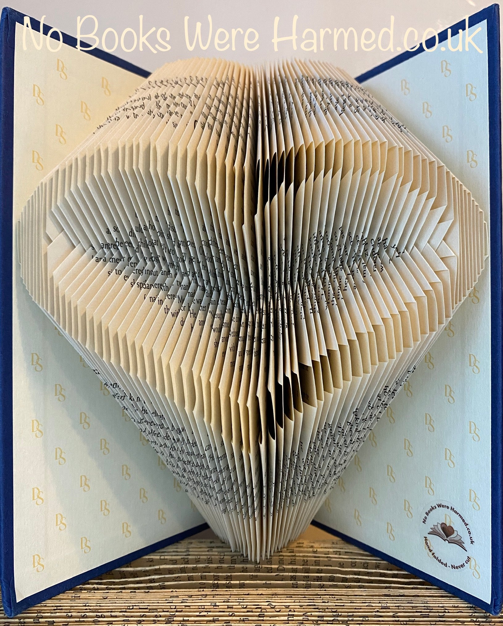 Handcrafted Open Heart art piece made from vintage book pages, showcasing intricate folds and unique design.