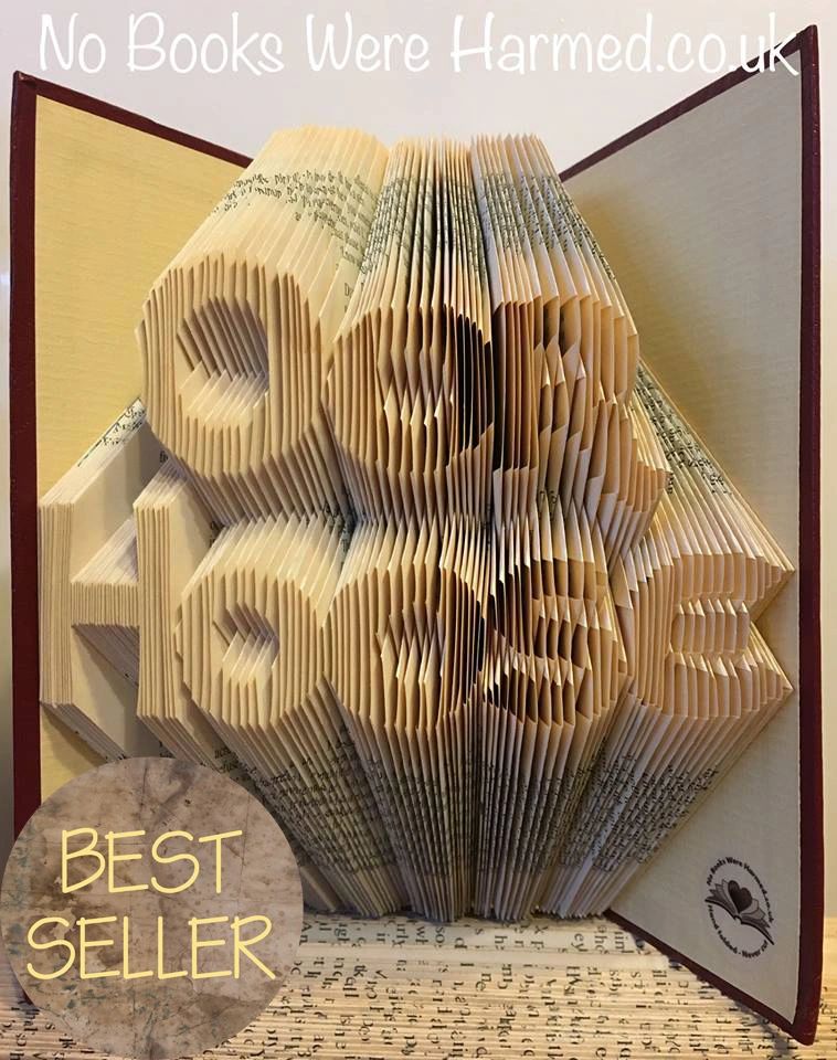 Handcrafted book art piece made from vintage books, showcasing intricate page folds and unique design.