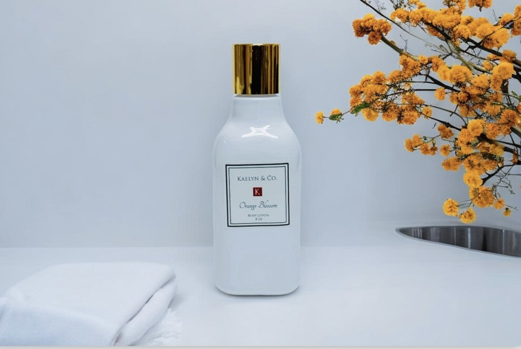 A bottle of Orange Blossom Body Lotion, 8oz, featuring a floral and citrus design, showcasing its hydrating properties and natural ingredients.