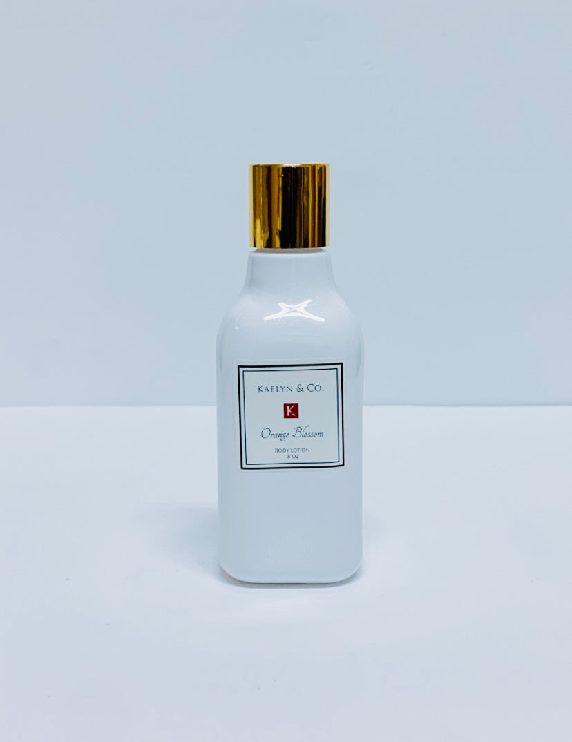 A bottle of Orange Blossom Body Lotion, 8oz, featuring a floral and citrus design, showcasing its hydrating properties and natural ingredients.