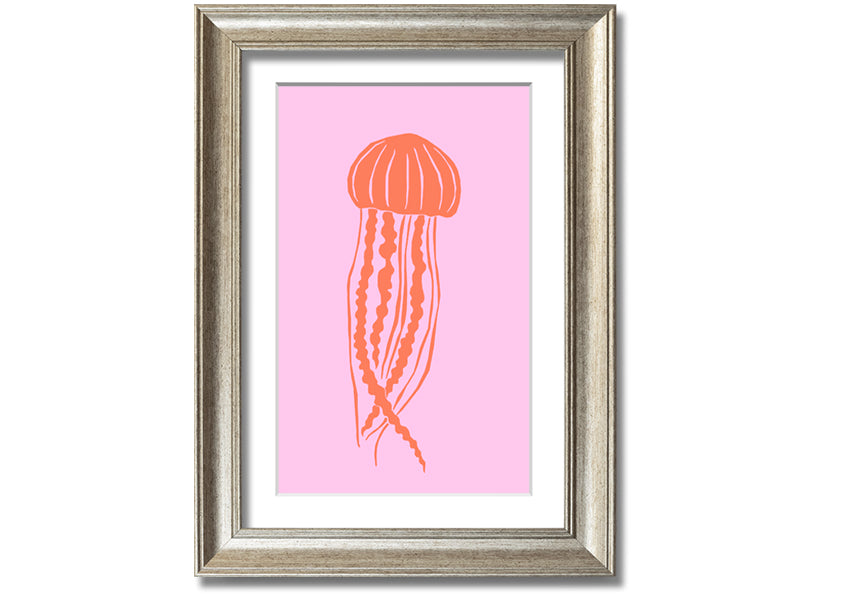 Framed print of an orange jellyfish on a pink background, showcasing vibrant colors and intricate details.