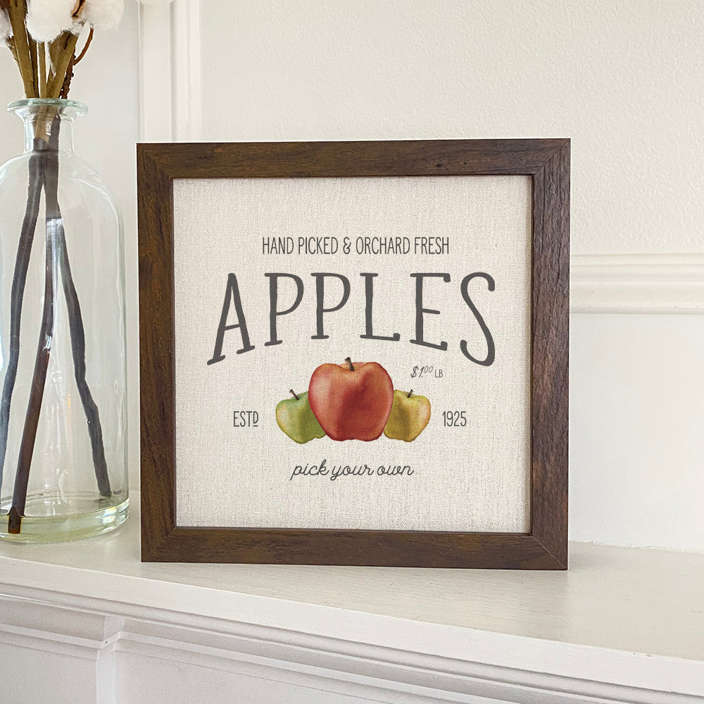 Orchard Fresh Apples framed sign with a stylized wood frame, featuring eco-friendly printing on a linen-look background.