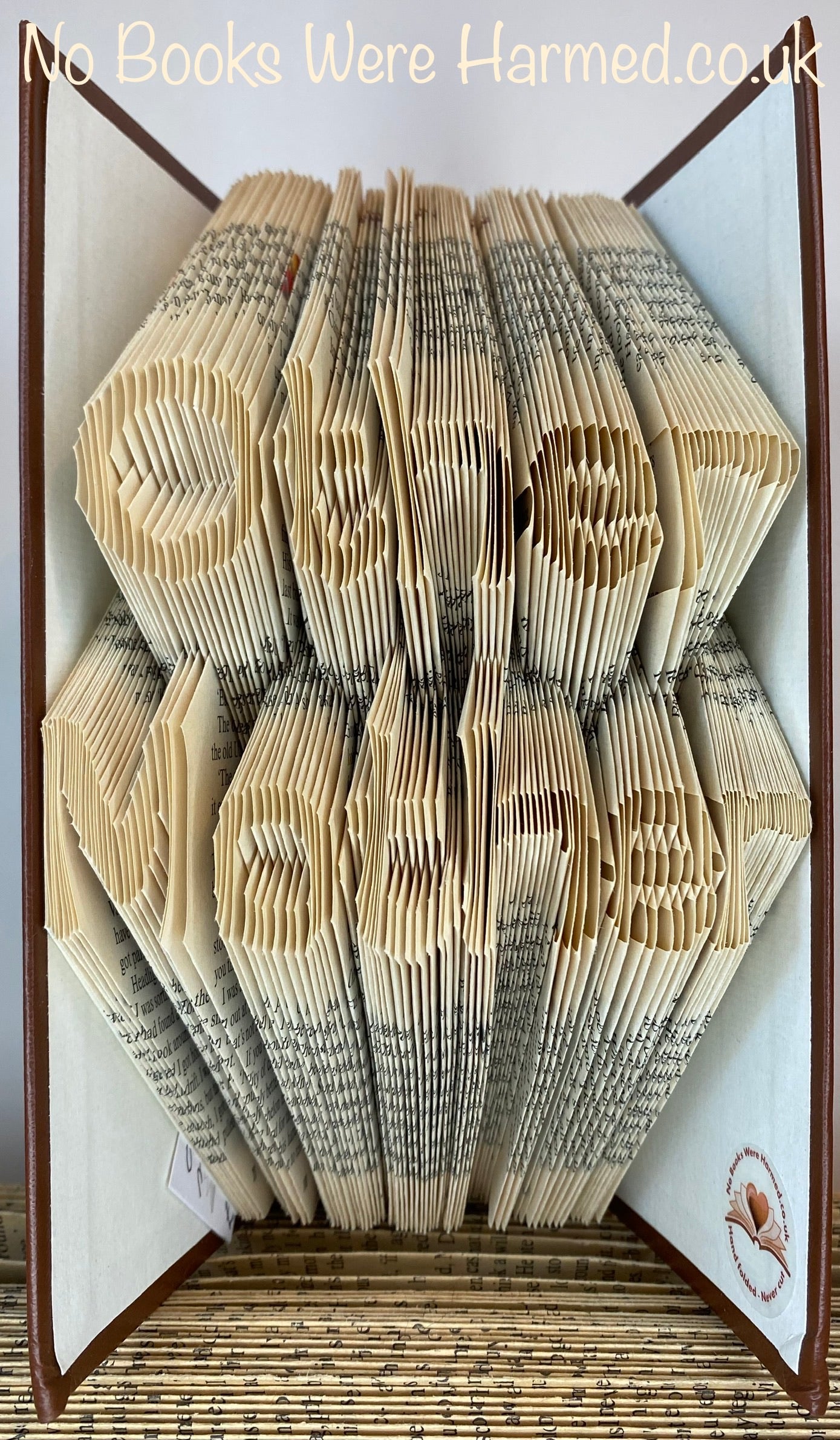 Hand-folded book art titled 'Other Mother', showcasing intricate designs made from vintage book pages.