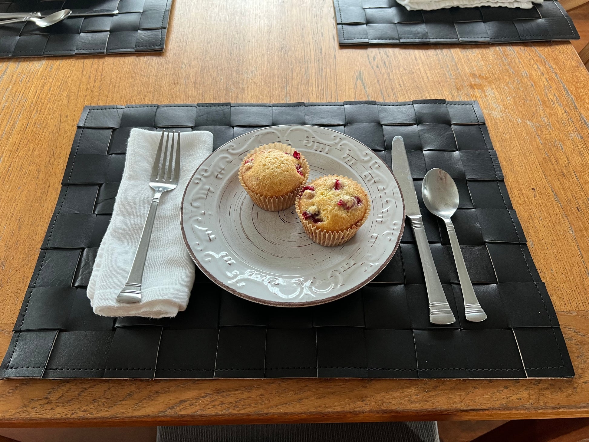 A set of four handmade leather placemats made from premium cowhide, showcasing a rustic and elegant design.