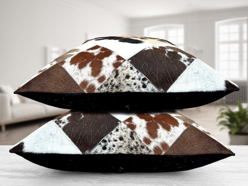 Pack of two genuine cow skin leather cushion covers with a mixed tricolor design of black, brown, and white, showcasing unique patterns.