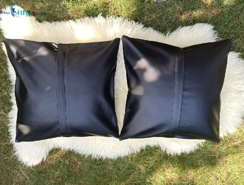 Pack of two genuine cow skin leather pillow covers with unique tricolor patterns in black, brown, and white, showcasing a luxurious texture.