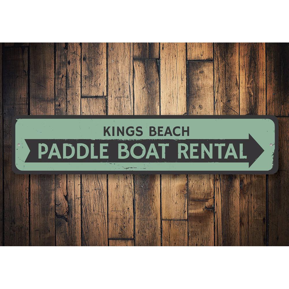 A vibrant Paddle Boat Rental Sign made of durable aluminum, featuring customizable text and pre-drilled holes for easy mounting, perfect for beach-themed decor.