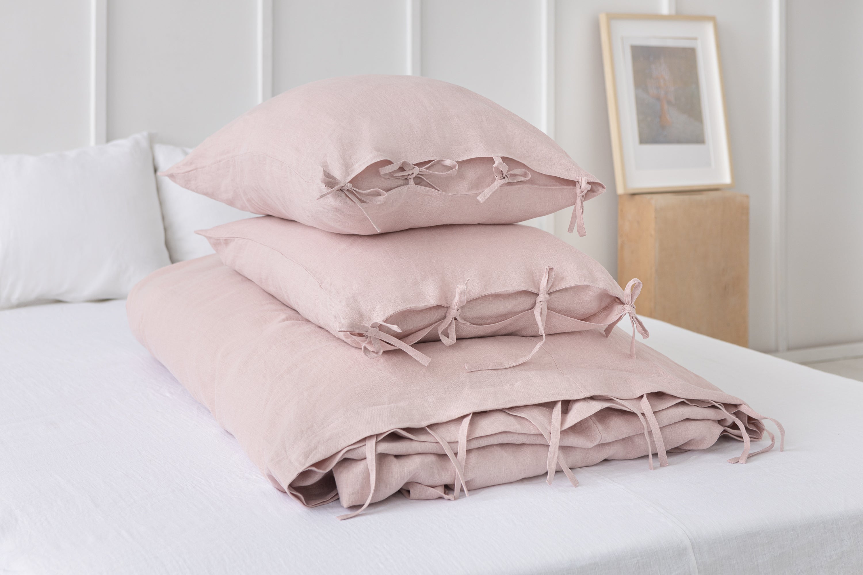 Pale Pink linen bedding set featuring duvet cover, bedsheet, and pillowcases with tie closures, elegantly styled for a minimalist bedroom.