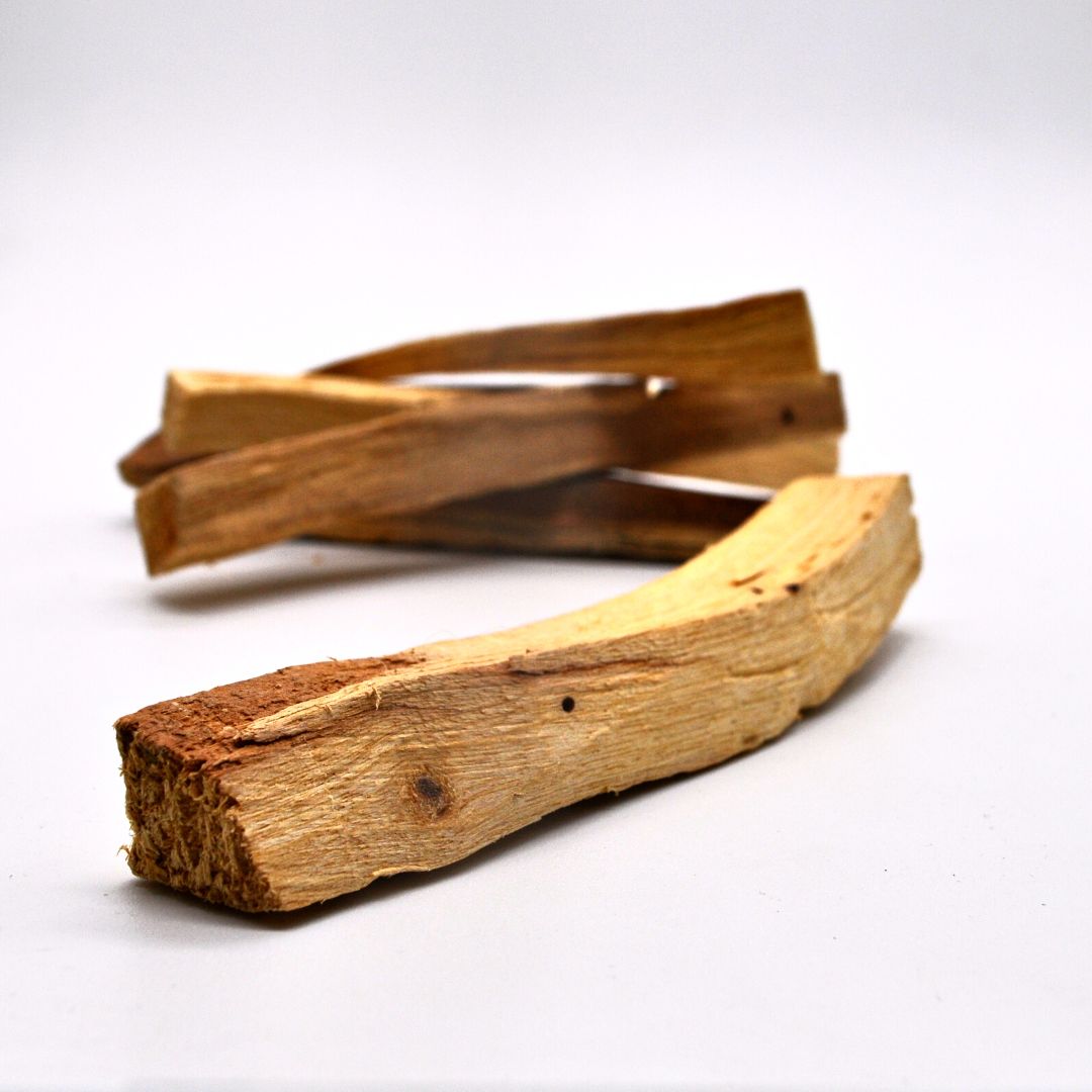 A collection of Grade 1 Palo Santo sticks, ethically sourced, showcasing their natural wood texture and color.