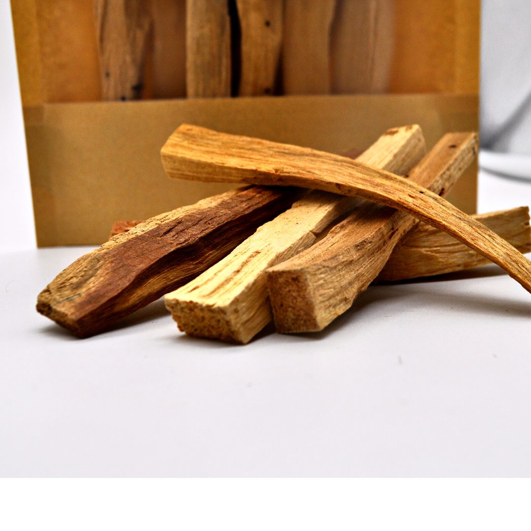 A collection of Grade 1 Palo Santo sticks, ethically sourced, showcasing their natural wood texture and color.