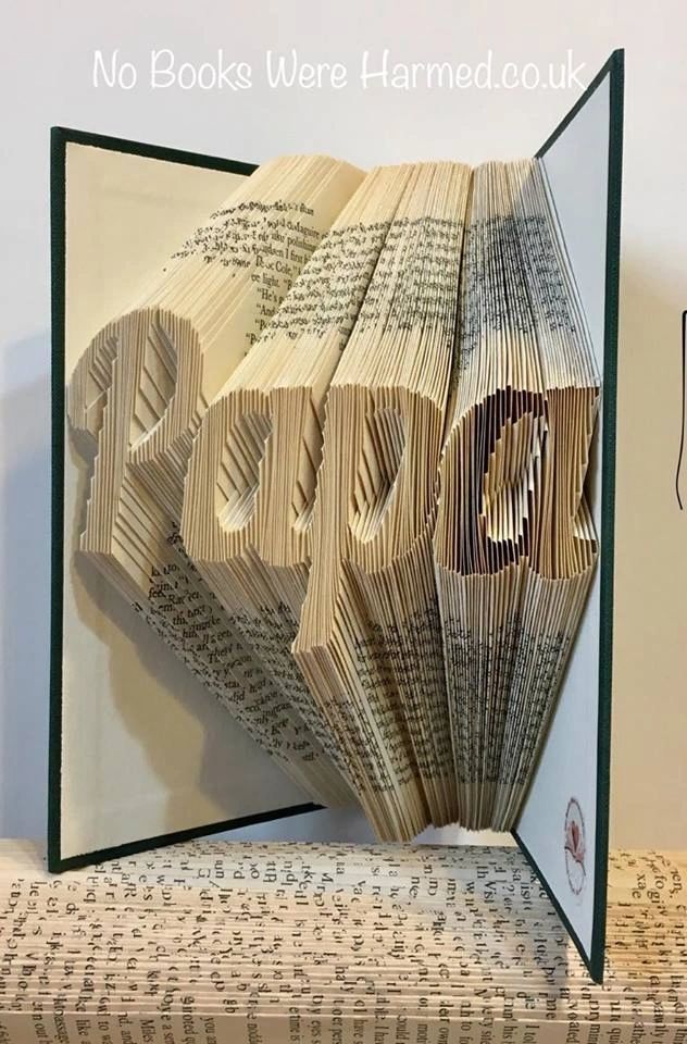 Hand-folded book art piece named 'Papa', crafted from vintage books, showcasing intricate designs and unique colors.