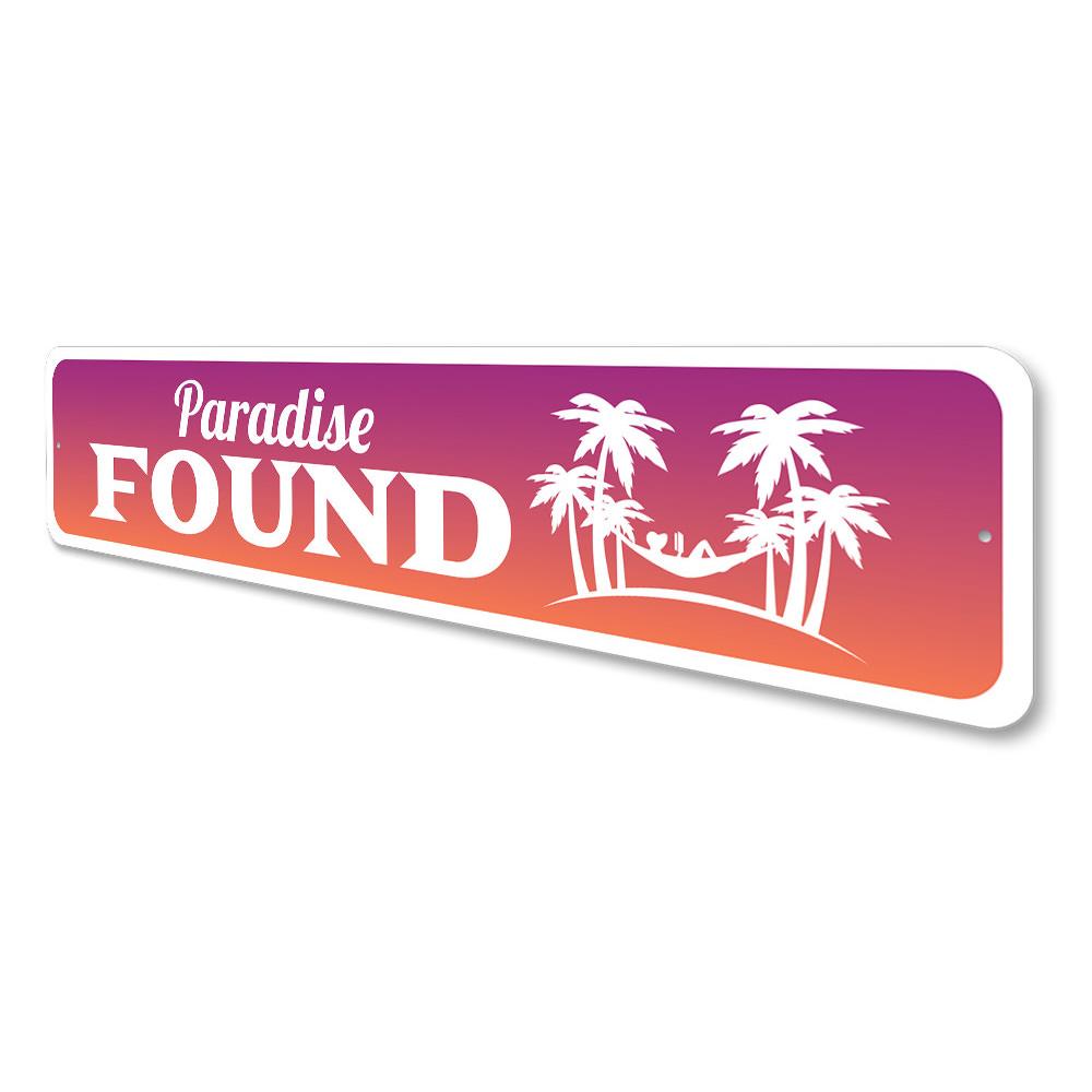 A beautifully crafted Paradise Found Sign made from high-quality aluminum, featuring beach-themed design elements, perfect for coastal decor.