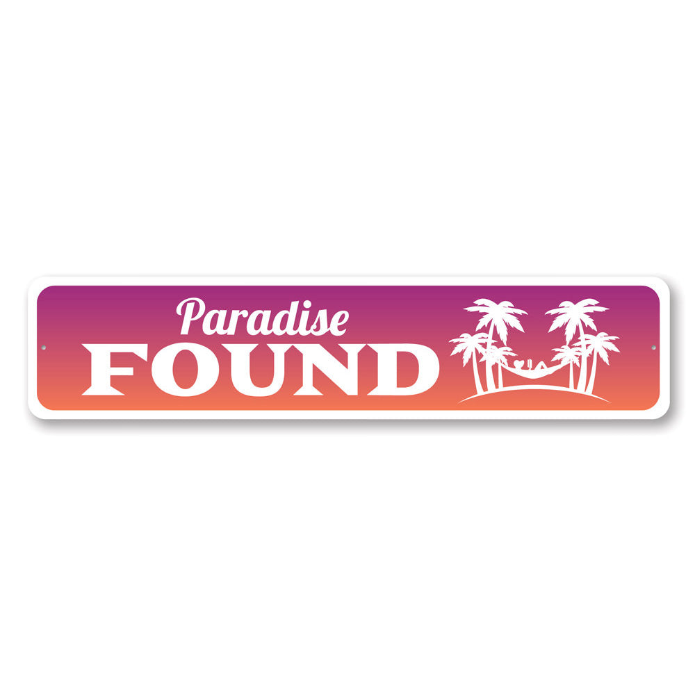 A beautifully crafted Paradise Found Sign made from high-quality aluminum, featuring beach-themed design elements, perfect for coastal decor.