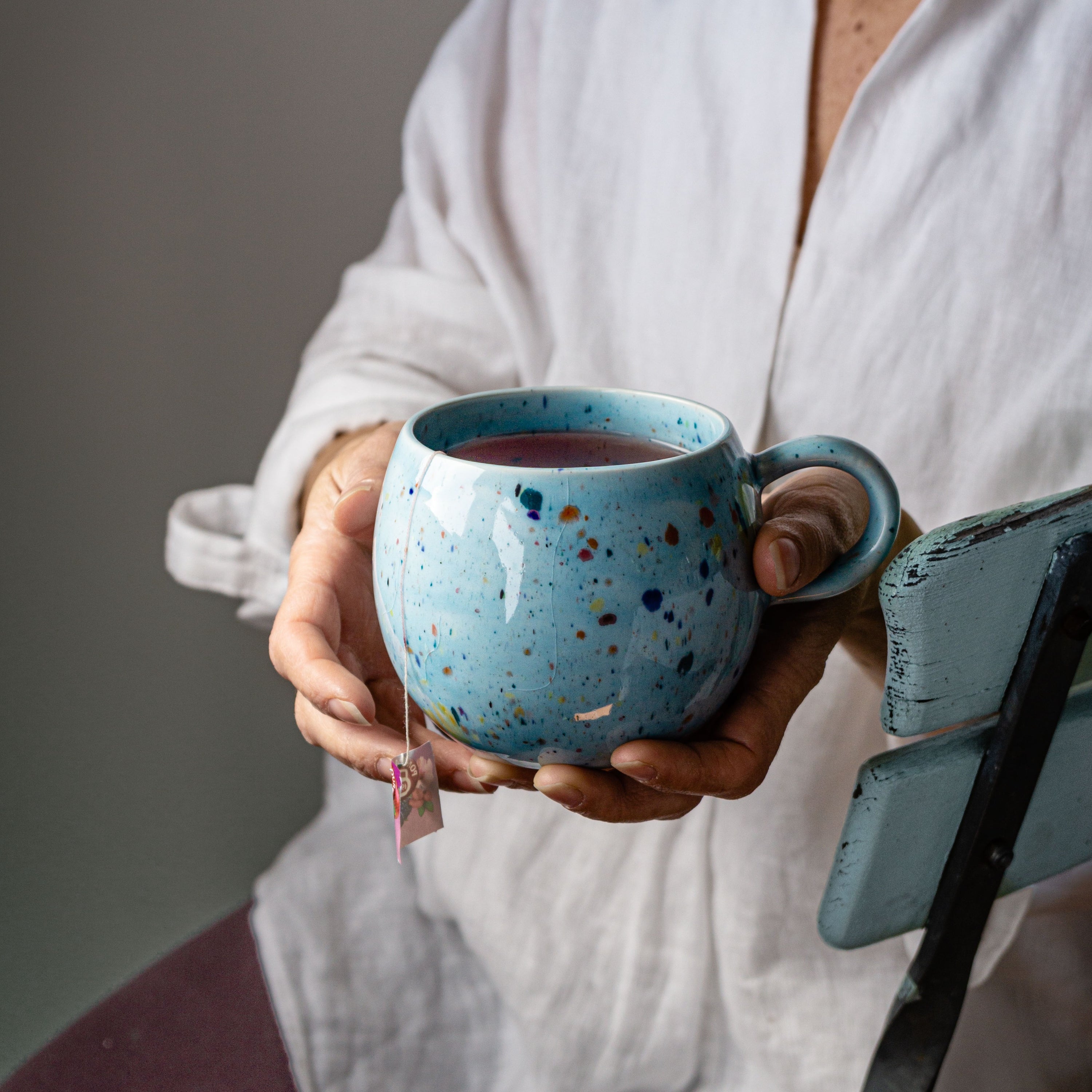 A vibrant blue ceramic Party Ball Mug with a shiny glaze finish, showcasing its unique handmade imperfections and elegant design.