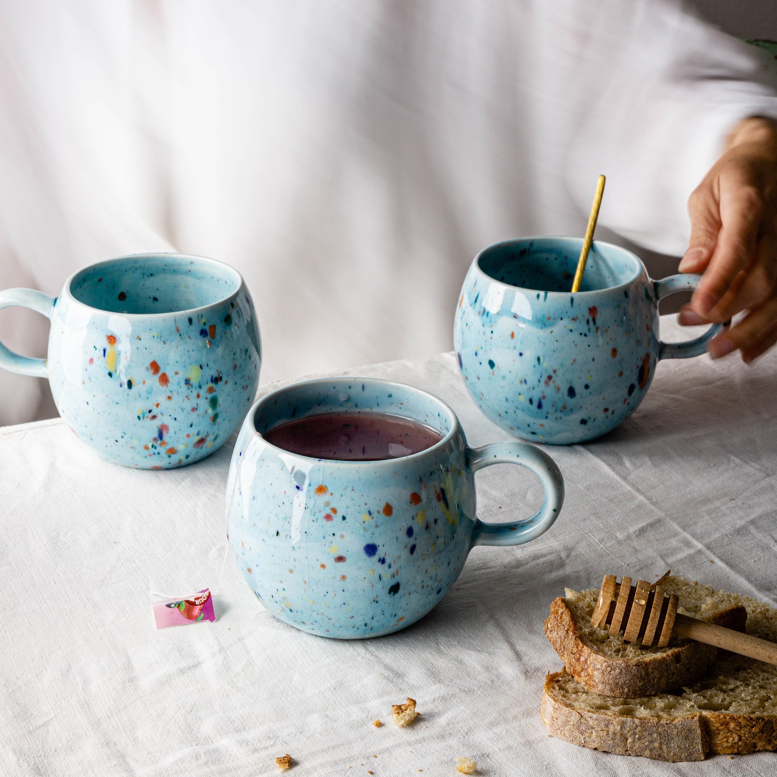 A vibrant blue ceramic Party Ball Mug with a shiny glaze finish, showcasing its unique handmade imperfections and elegant design.