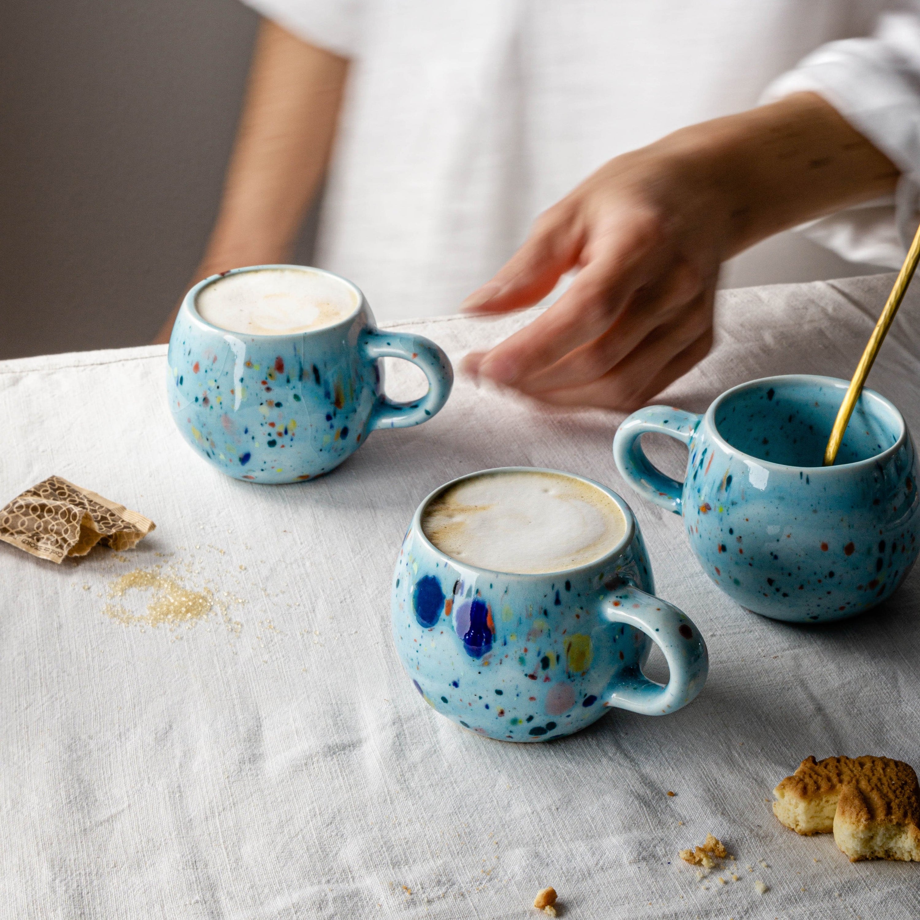 A vibrant blue ceramic Party Ball Mug with a shiny glaze finish, showcasing its unique handmade imperfections and elegant design.