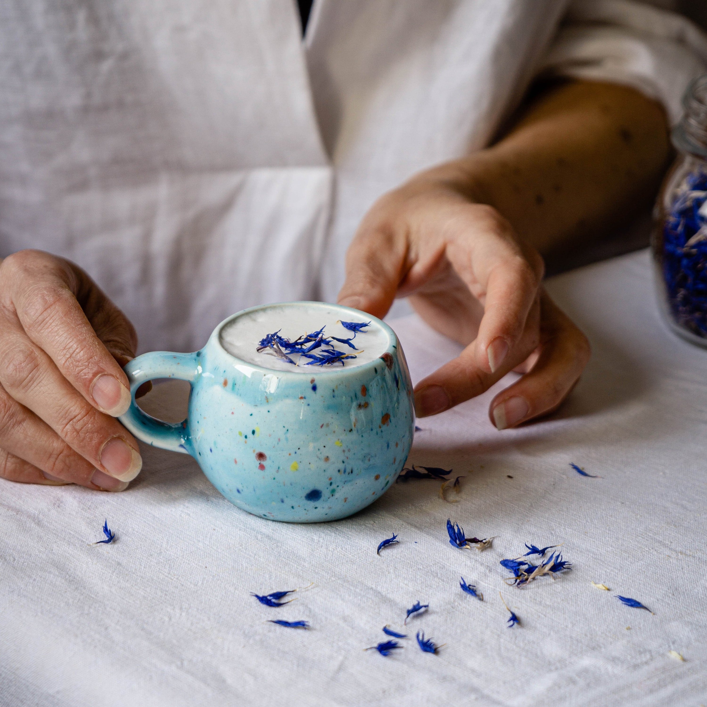 A vibrant blue ceramic Party Ball Mug with a shiny glaze finish, showcasing its unique handmade imperfections and elegant design.