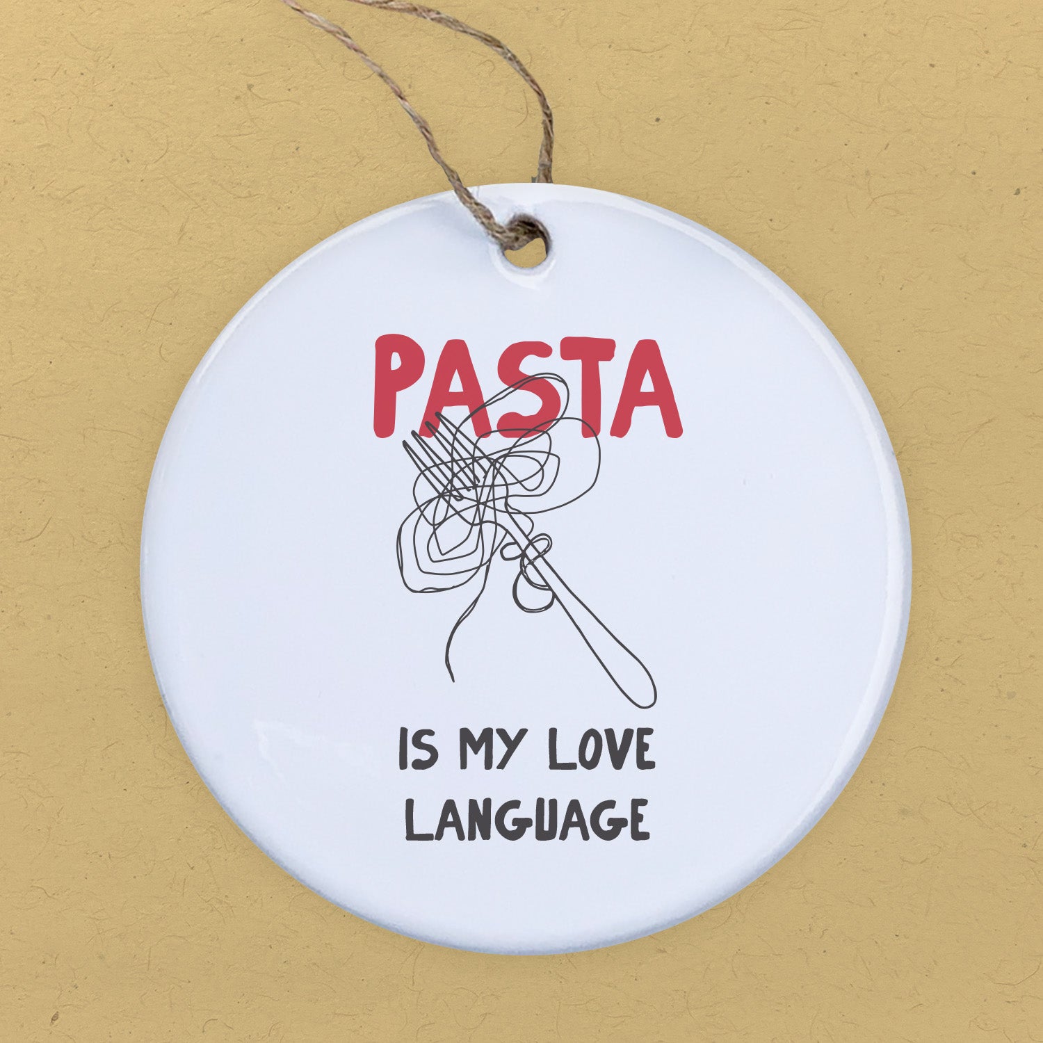 A beautifully crafted porcelain ornament featuring the phrase 'Pasta Is My Love Language', showcasing vibrant colors and a glossy finish.