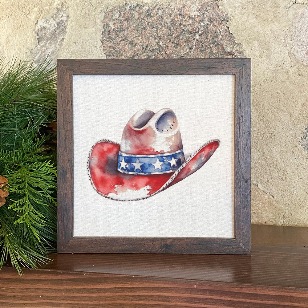 A beautifully framed sign featuring a patriotic cowboy hat design, set against a neutral linen-look background with eco-friendly ink printing.