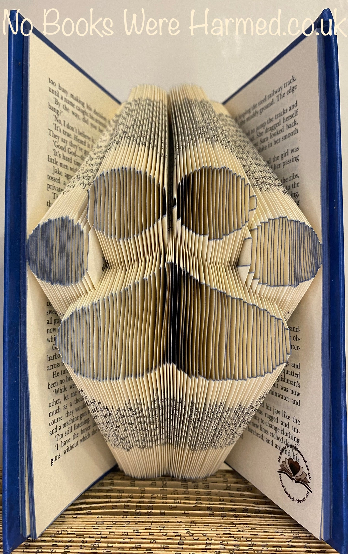 Handcrafted Paw with Heart Pad art piece made from vintage book pages, showcasing intricate folds and unique design.