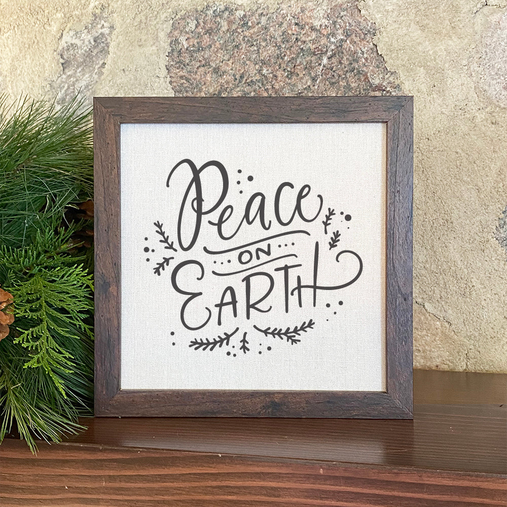 Peace on Earth framed sign with a stylized wood frame, featuring eco-friendly printing on a linen-look background.