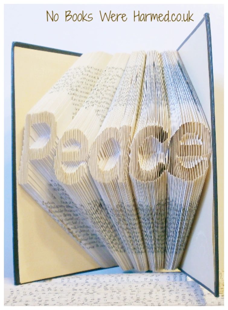 Hand-folded book art titled 'Peace', showcasing intricate designs from vintage book pages.