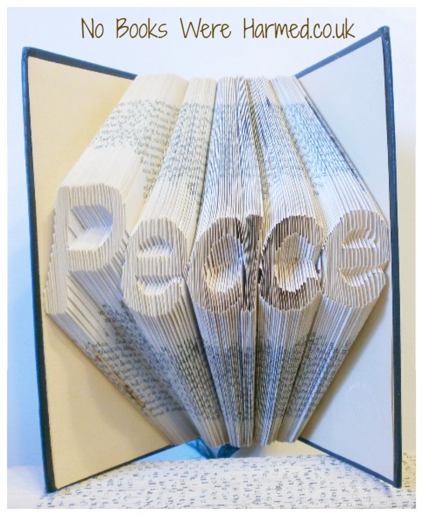 Hand-folded book art titled 'Peace', showcasing intricate designs from vintage book pages.