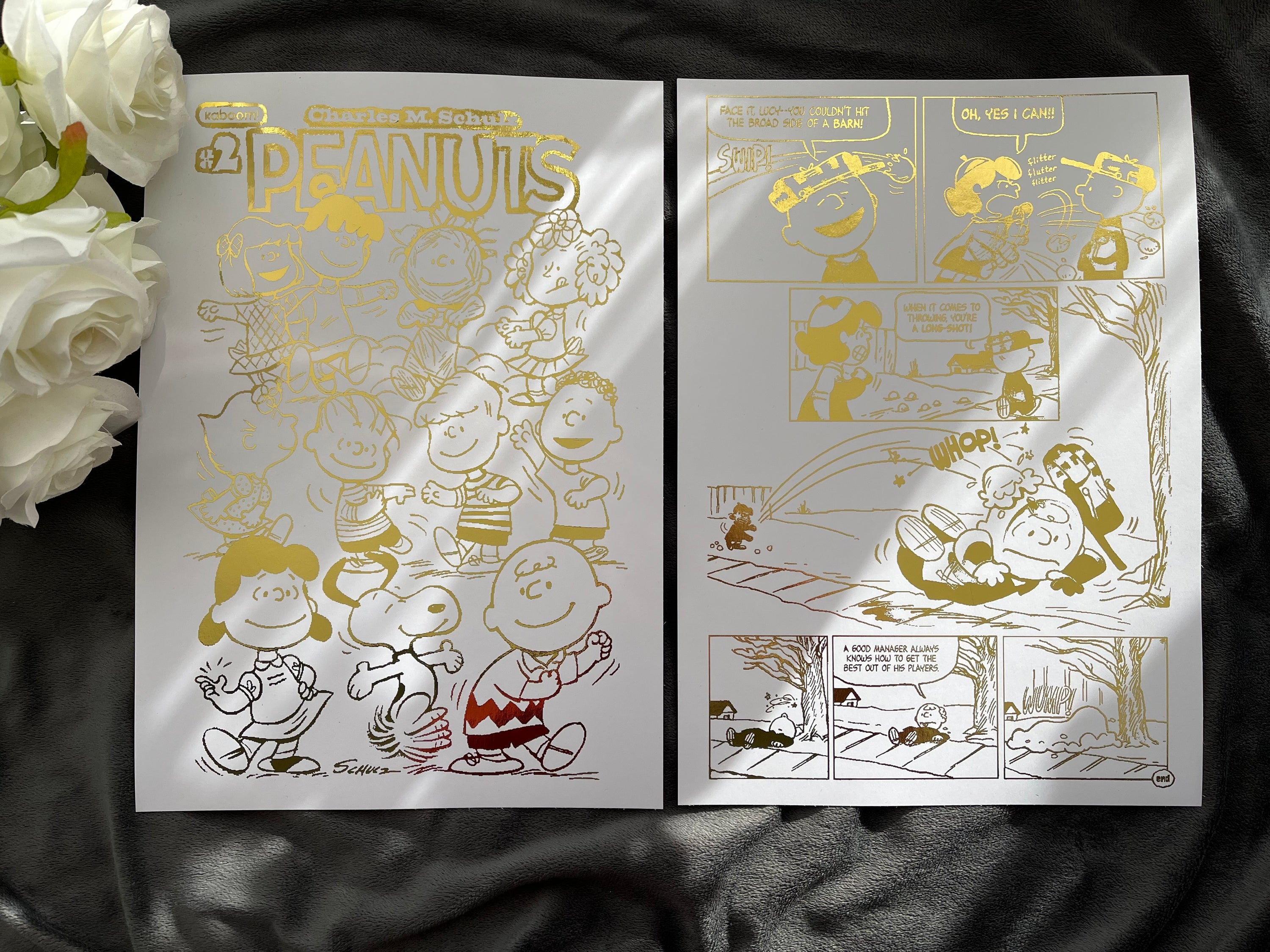 Peanuts Comic Cover & Comic Strip Foil Print featuring Charlie Brown, Snoopy, and other iconic characters in gold foil accents.