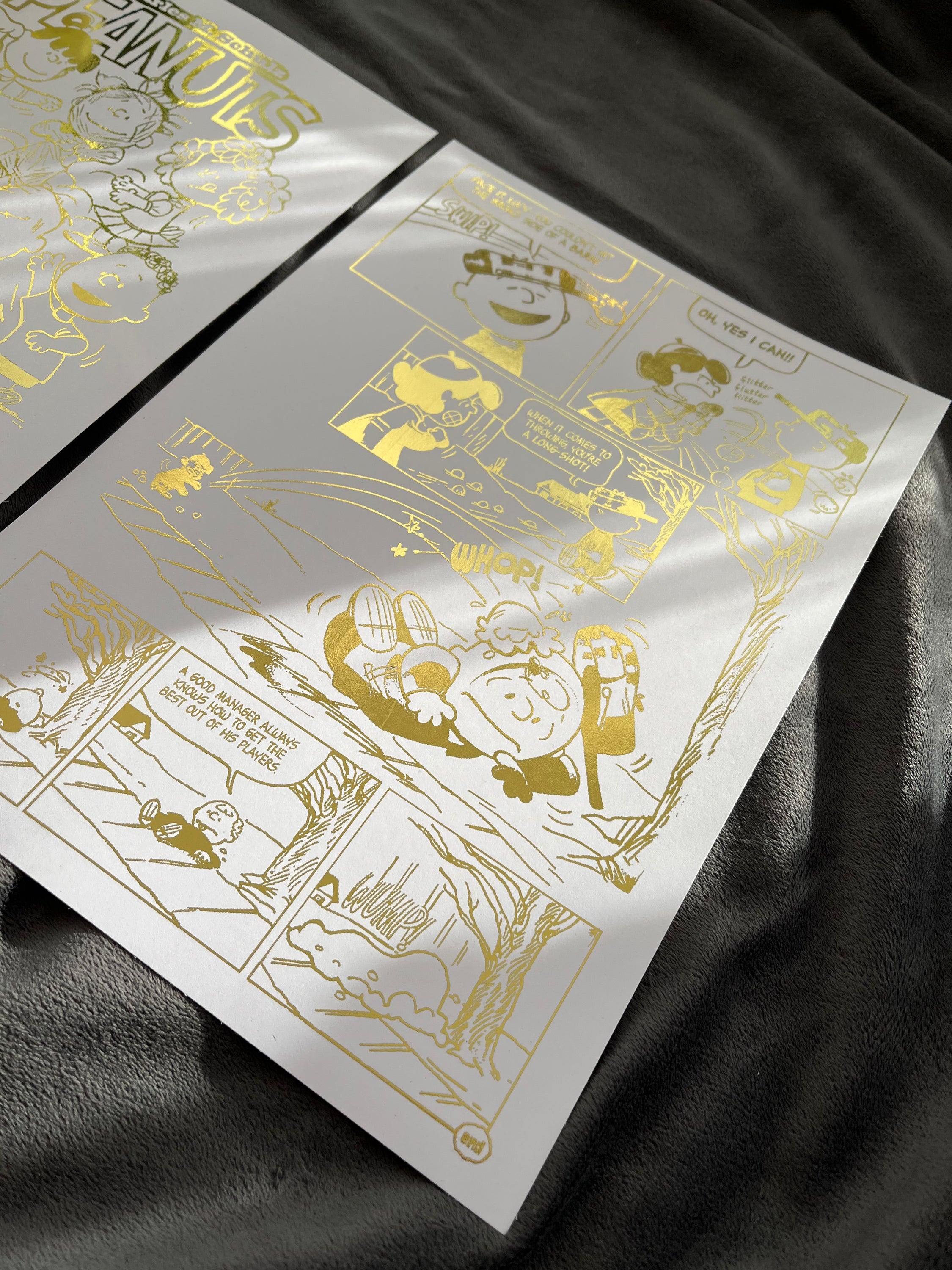 Peanuts Comic Cover & Comic Strip Foil Print featuring Charlie Brown, Snoopy, and other iconic characters in gold foil accents.