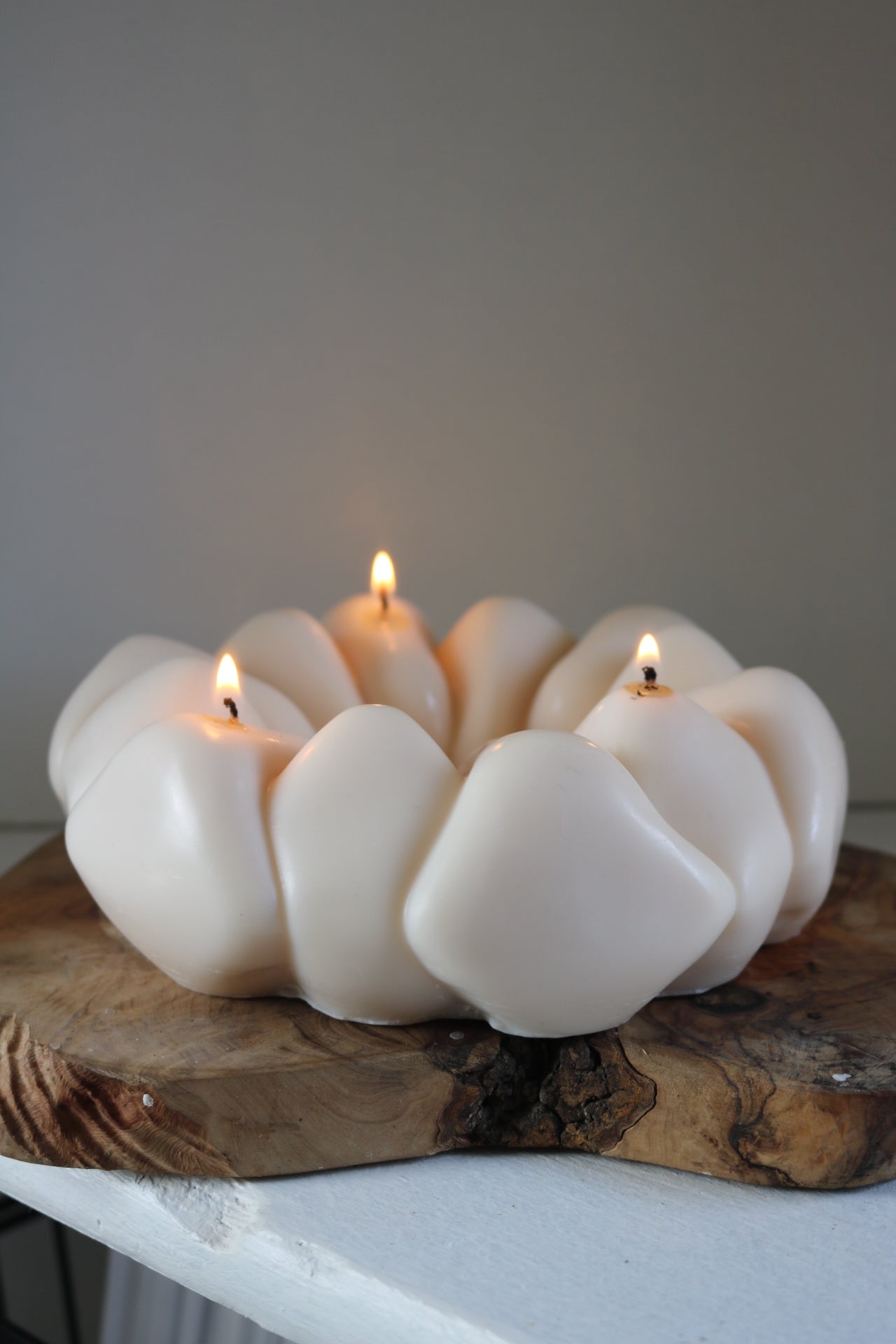 A beautifully crafted pebble wreath candle made from a soy wax blend, showcasing its sculptural design and neutral tones, perfect for home decor.