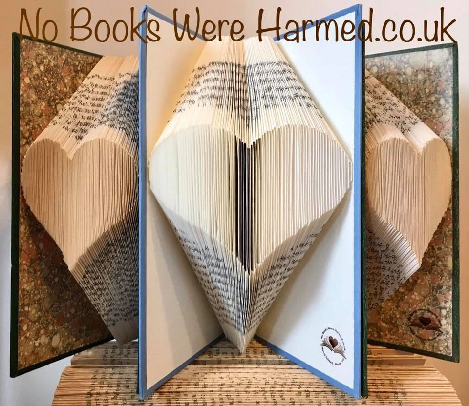 A handcrafted heart made from the pages of vintage books, showcasing intricate folds and unique textures.