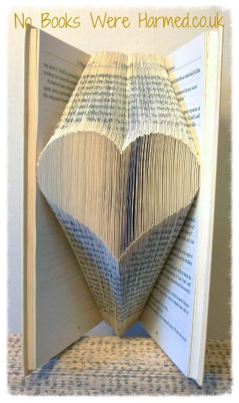 A handcrafted heart made from the pages of vintage books, showcasing intricate folds and unique textures.