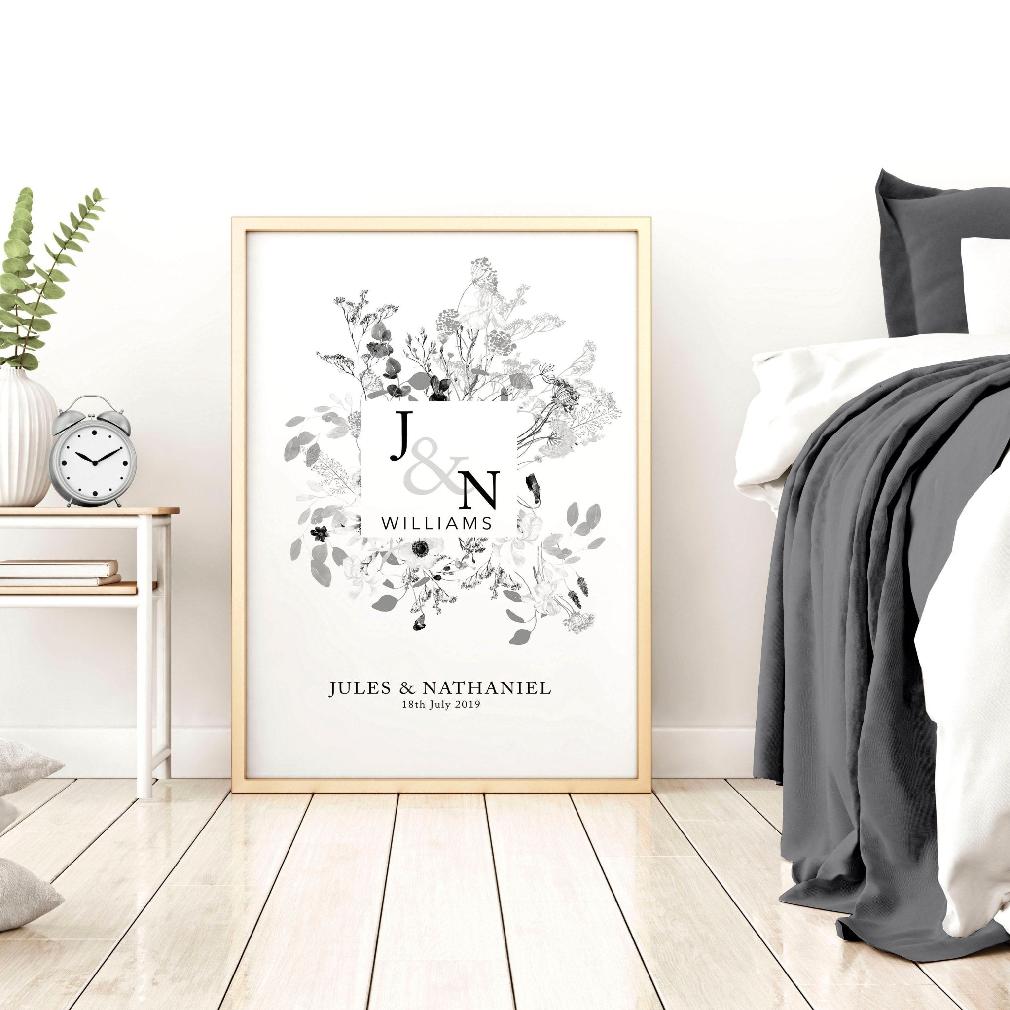 Personalised wedding anniversary wall art print featuring a botanical monogram design in neutral grey, customised with names and anniversary details.