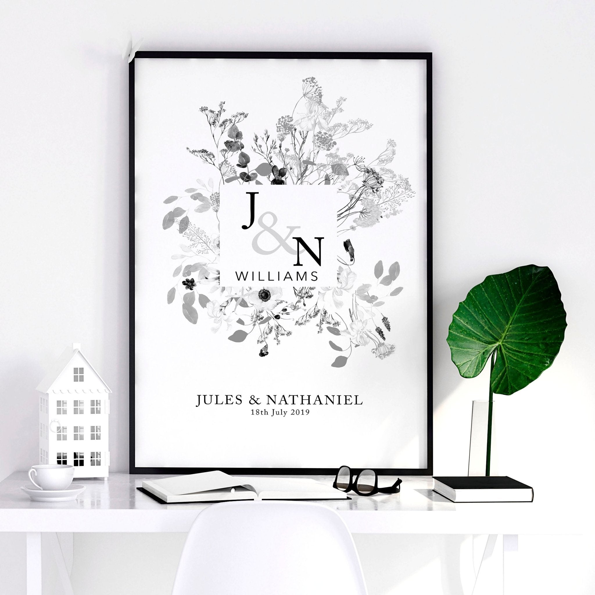 Personalised wedding anniversary wall art print featuring a botanical monogram design in neutral grey, customised with names and anniversary details.